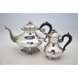 A French 950 grade tea pot of compressed baluster form, with floral finial and scroll-cast feet,