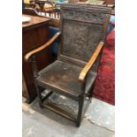 A late 17th/18th century oak Wainscot chair, the joint frame with carved rails centred by a carved