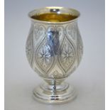 A Victorian parcel gilt silver beaker in the Jacobean manner with ovoid body on stemmed foot,
