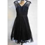 A 1950s black evening gown with triple net under-skirts, a Stamp-Taylor model, 40 cm across chest,