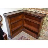 A late 19th century mahogany corner bookcase, with adjustable open shelves and raised on a plinth