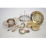 Various table silver including a toast-rack, tea strainer and associated stand, caddy spoon with