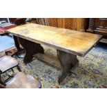 A substantial pollard oak/elm table, the two plank top raised on shaped trestle ends united by a