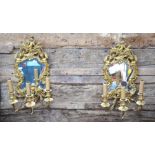 A pair of good quality gilt ormolu mirror backed twin arm wall sconces in the Louis XV style, 46