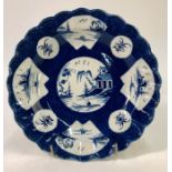 An 18th century Worcester fluted bowl painted in blue with the 'fan-panelled landscape' pattern.