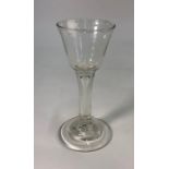 An 18th century style wine glass, bucket bowl, plain stem with long teardrop, domed foot and rough