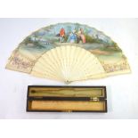 A 19th century French ivory fan, the paper leaf painted with 18th century courtly figures in a
