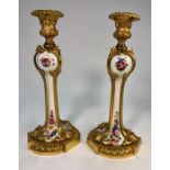 A pair of French late 19th century ormolu and porcelain candlesticks with polychrome floral