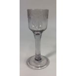 An 18th century wine glass, ogee bowl engraved with with cross-hatch and swag decoration and