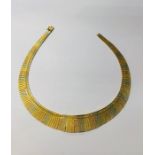 A three-coloured white, rose and yellow metal Cleopatra style necklace formed of engraved panels