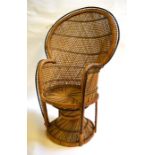 A 1960s rattan Peacock chair raised on four legs and circular base