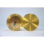 A Tiffany & Co lacquered brass travel alarm clock with quartz movement, in drum case with