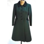 A Petit Francaise emerald green coat with embroidered green velvet collar and pocket trims, with