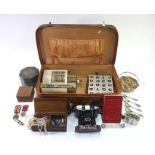A vintage leather suitcase, containing various collectables, including Zeiss Ikon camera,