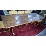 An old reclaimed oak refectory table, the wide three plank cleated end top raised on shaped