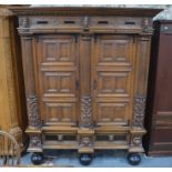 An antique Dutch oak and carved oak press cupboard, 18th century, the cornice over a blind fret