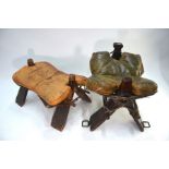 An antique wood framed camel seat with leather cushion seat, the harness mounts stamped ''ANN' to/