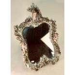 A Dresden porcelain easel mirror surmounted by the head and shoulder bust of a lady, a cherub on