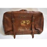 A Fortnum & Mason heavy tan leather travel holdall with vintage part travel labels, 78 x 46 cm to/