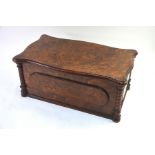 A Victorian birds eye walnut casket, the hinged top enclosing numerous coompartments, probably