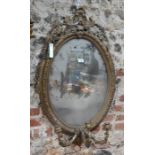 An antique oval git framed girandole mirror with a trio of scroll arm candle sconces - a/f, 100 cm h