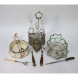 A Victorian electroplated three-bottle stand fitted with cut glass spirit decanters and stoppers,