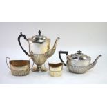 A matched four piece silver tea/coffee service of oval half-reeded form, the coffee pot on stemmed