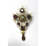 An Arts and Crafts yellow gold brooch of scroll foliate design set with central bossed pearl and
