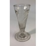 An 18th century short ale glass, part wrythen conical bowl, short knopped stem, conical folded foot,