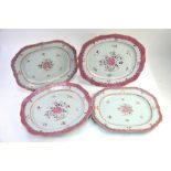 Four Chinese, famille rose dishes or tureen stands, comprising: a pair with foliate rims, 36 cm