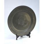 An 18th century/early 19th century English pewter charger with moulded rim, London marks, 46 cm