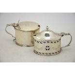 A George III silver oval mustard of plain form with hinged cover, reeded rims and scroll handle,