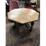 A late 19th century Arts & Crafts oak centre table, the octagonal top raised on four carved baluster