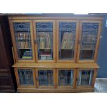 A tate 19th/20th century Arts & Crafts golden oak library bookcase, the arrangement of four lead