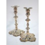 A pair of George II cast silver baluster candlesticks with unmarked detachable grease-pans, on