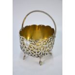 A Victorian pierced bonbon basket with beaded hinged handle and scroll feet, George Unite,