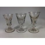 Three 19th century toastmaster's glasses, one with a conical bowl, blade knop stem and rough pontil,