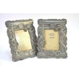 A pair of Japanese metal photograph frames; each one designed as dragons beside a torii gate