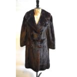 A dark brown mink fur coat with half belt to back, retailed by P. C. Winterson Ltd., London, 50 cm