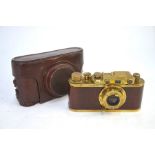 A replica Leica brass and wood camera, in vintage Leica leather case