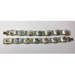 Two Norwegian bracelets formed of rectangular white guilloche enamel panels decorated with