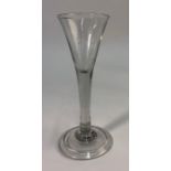 An 18th century wine glass, drawn trumpet bowl, plain stem, domed folded foot, rough pontil, 15.8 cm