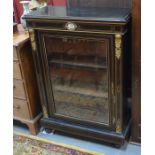 A Victorian gilt-metal mounted boxwood line inlaid ebonised pier cabinet, the single glazed door
