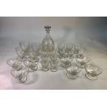 A French Baccarat part suite of drinking glasses and a matching decanter, all etced with a floral