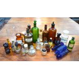 A collection of 30 coloured glass chemist's bottles - many with original labels