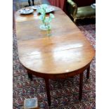 A Victorian mahogany D-end dining table comprising a pair of demi-lune end table united by a