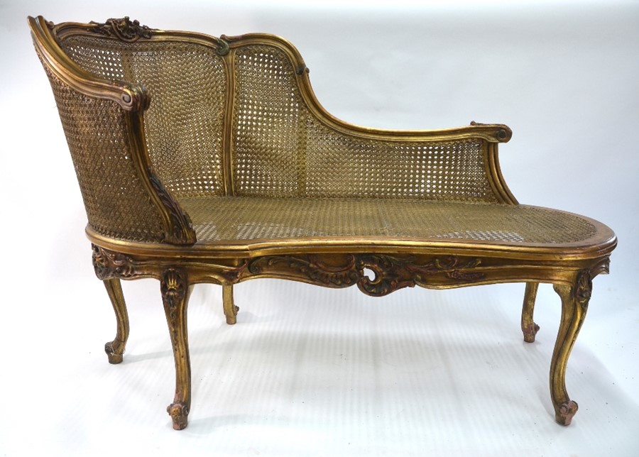 A Louis XV style giltwood framed bergere salon sofa, 140 cm long x 93 cm h o/a (the seat 44 cm h),