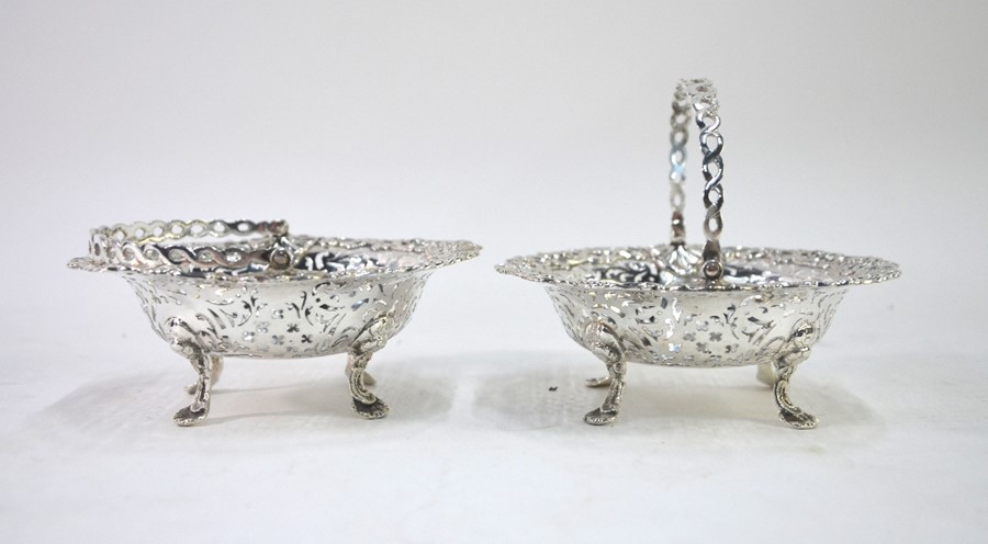 A pair of late Victorian pierced silver bonbon baskets with guilloche swing handles, on lion-mask - Image 2 of 3