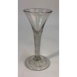 An 18th century style wine glass, drawn trumpet bowl, multi spiral air twist stem, conical folded