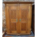 An antique Bavarian oak armoire,with moulded stepped cornice over a blind fret frieze